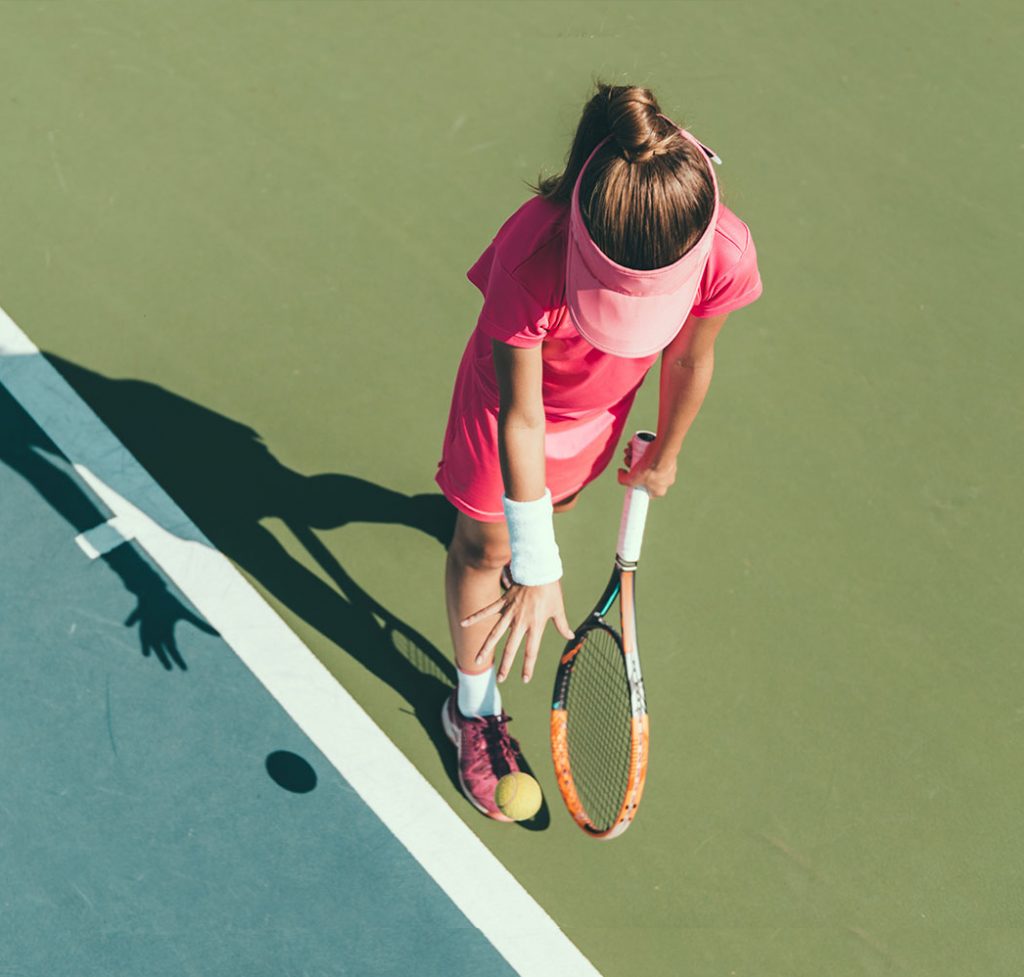 Woman playing tennis on tennis court